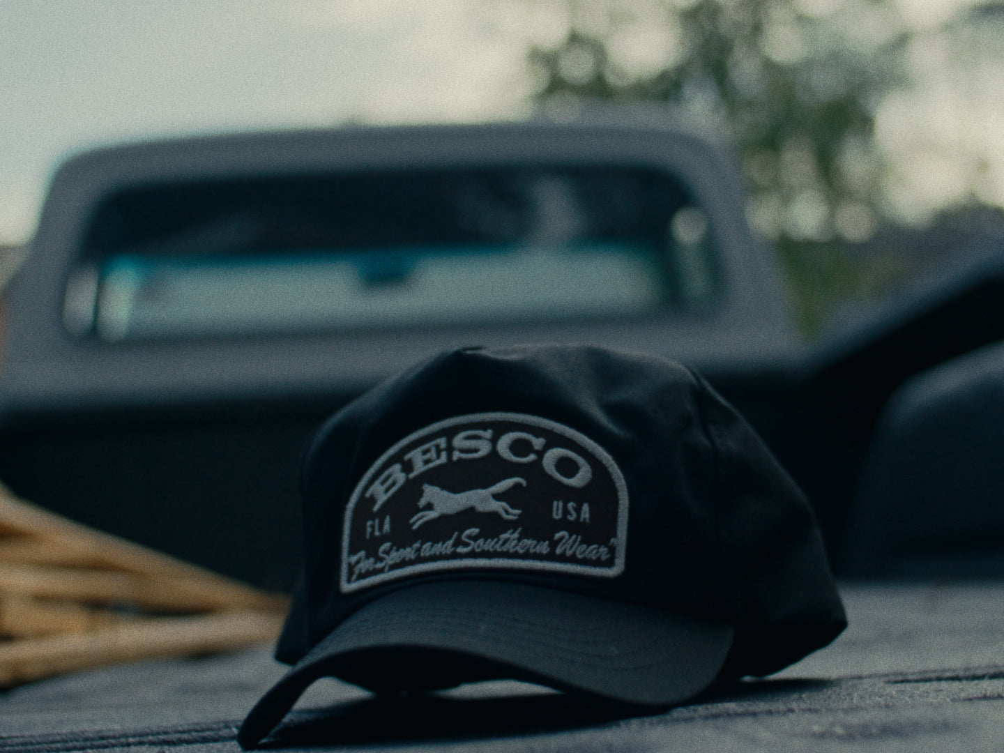 Close-up of a black Besco with the Fox Patch resting on the bed of a classic Ford pickup truck.
