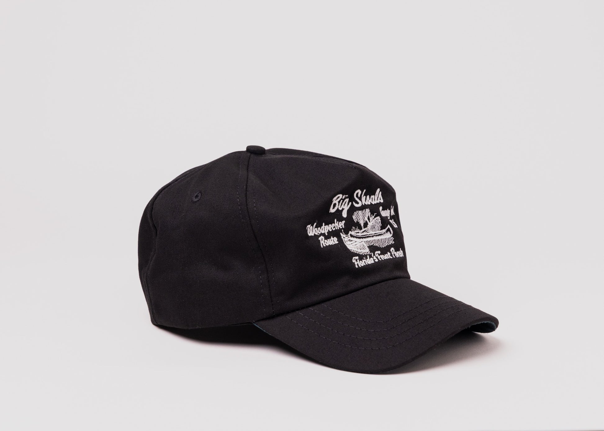Black Besco hat with white embroidered ‘Big Shoals’ and canoe design, angled front view on white background.