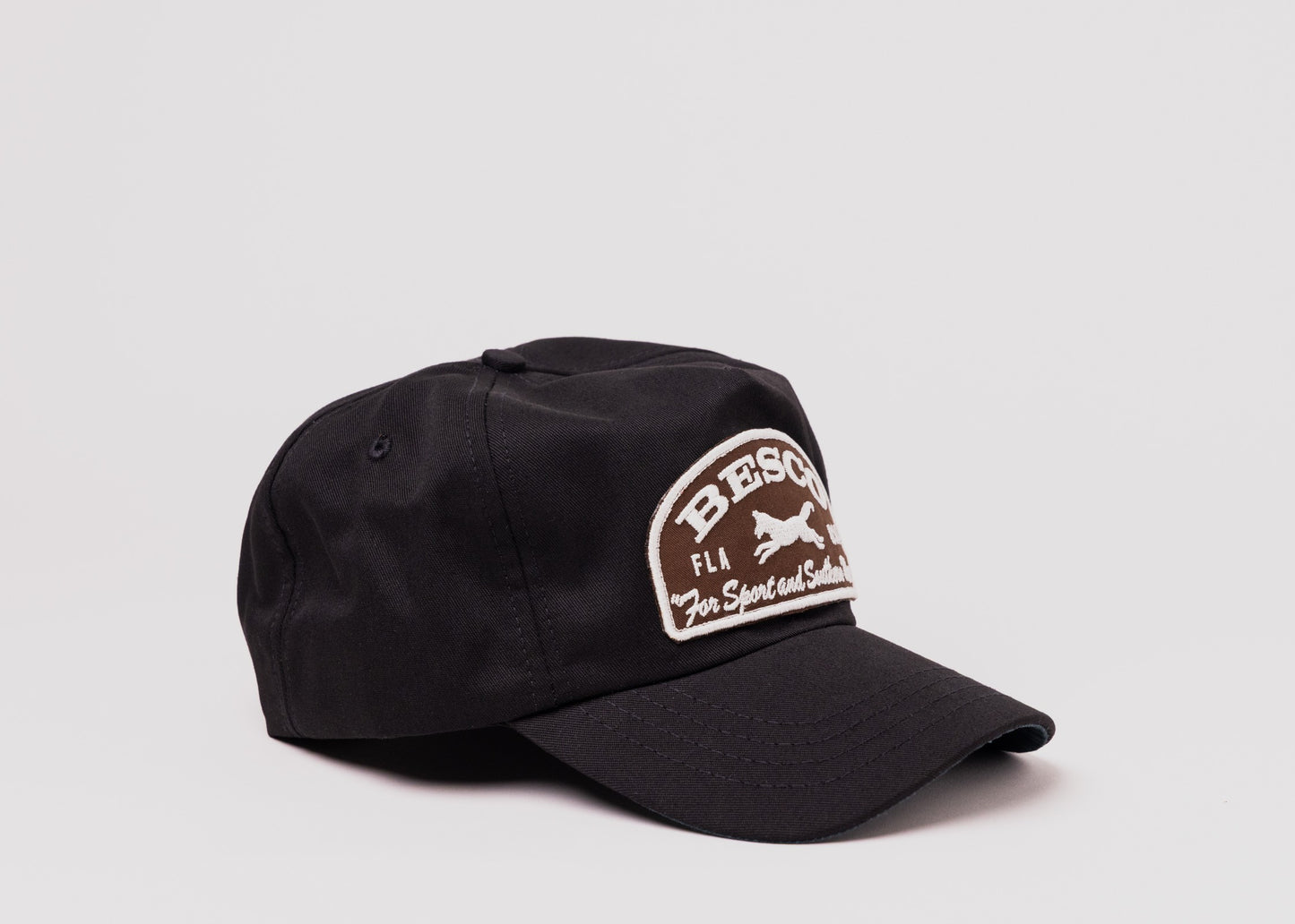Black Besco hat with brown and white embroidered fox patch reading ‘For Sport and Southern Wear,’ angled front view on white background.
