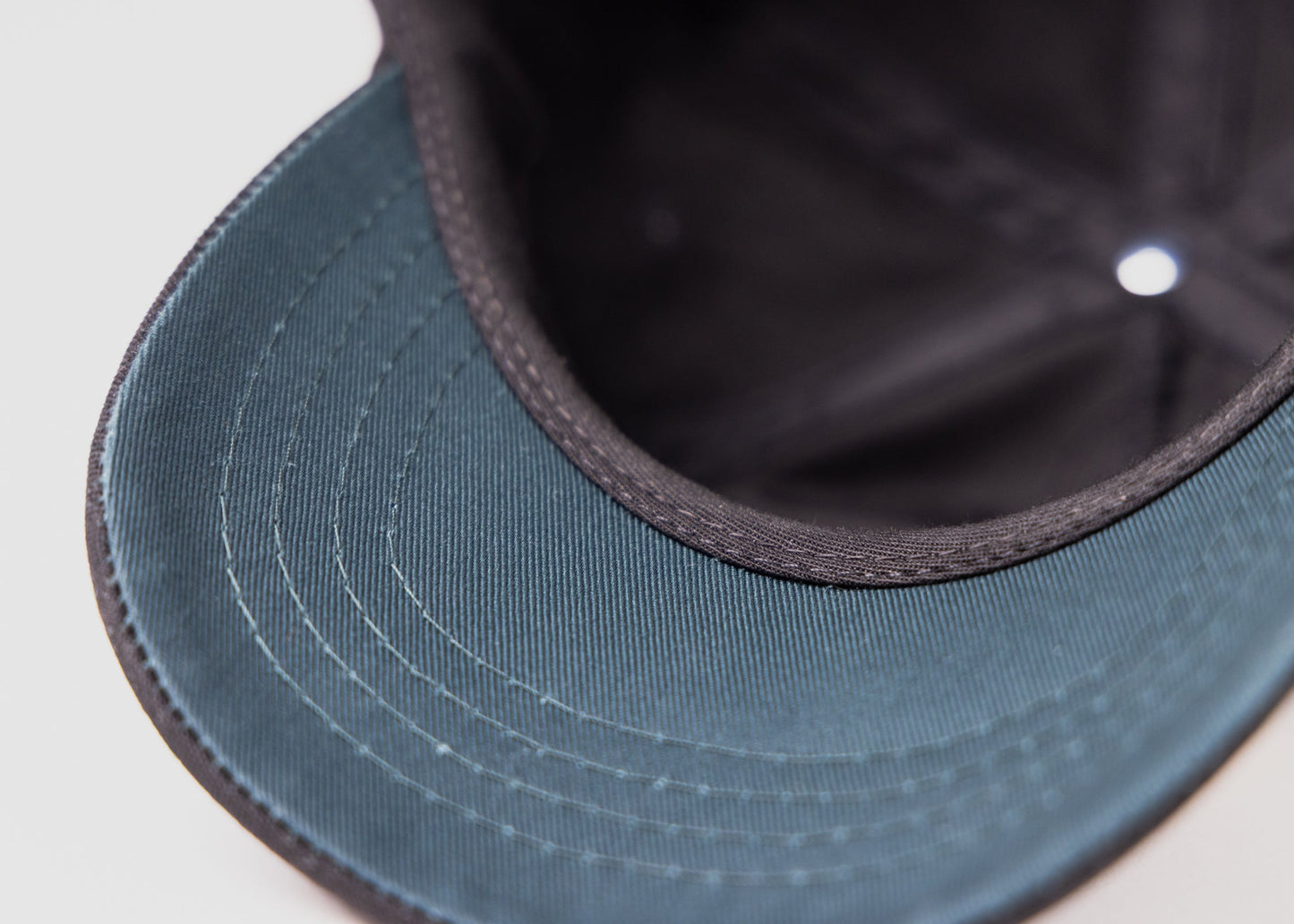 Underbill detail of black Besco hat showing deep green fabric color used for underbill.