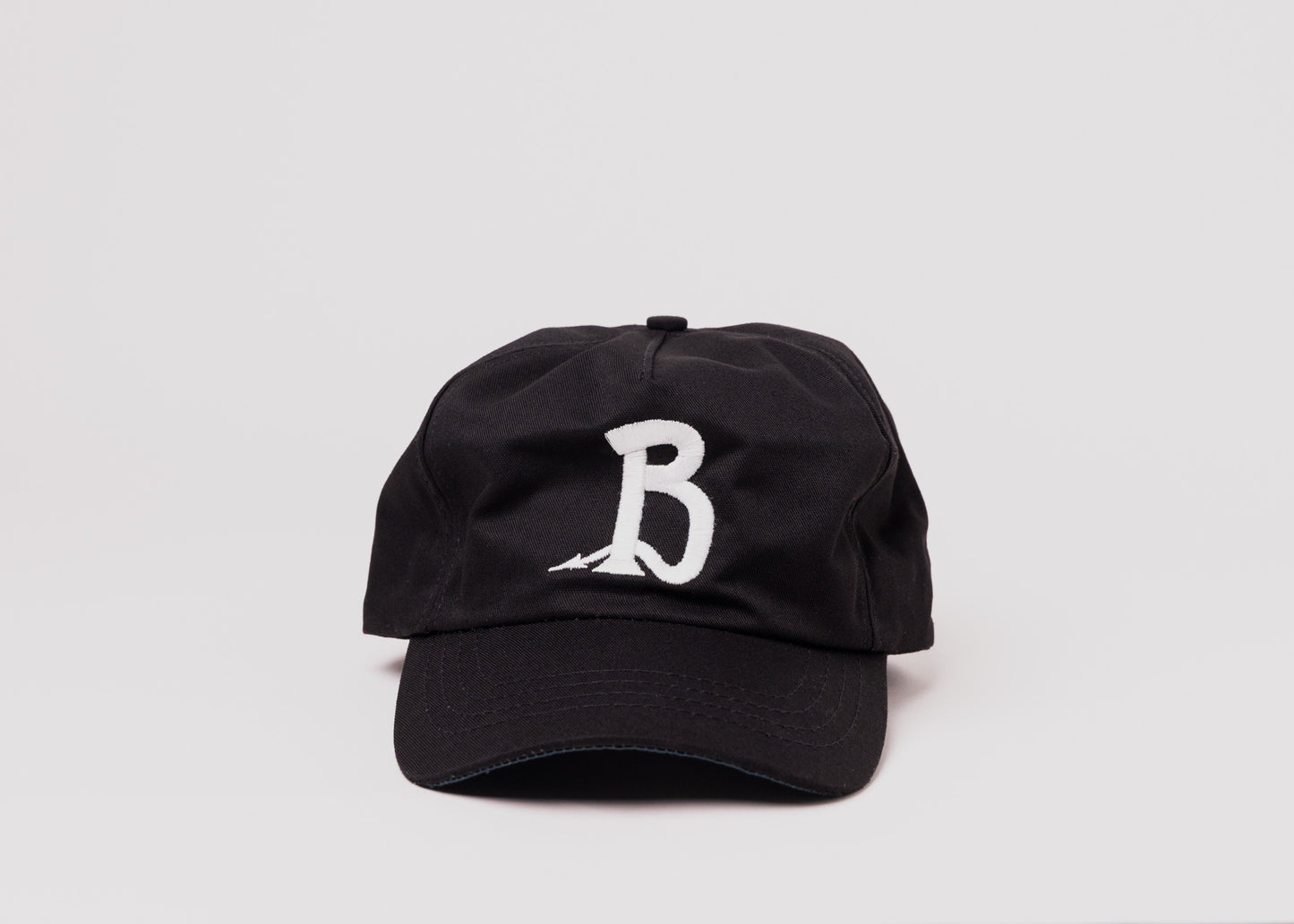 Black Besco hat with white embroidered letter 'B’ design, front view on white background.